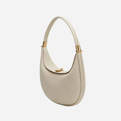 Beige luna handbag with gold accents on a white background